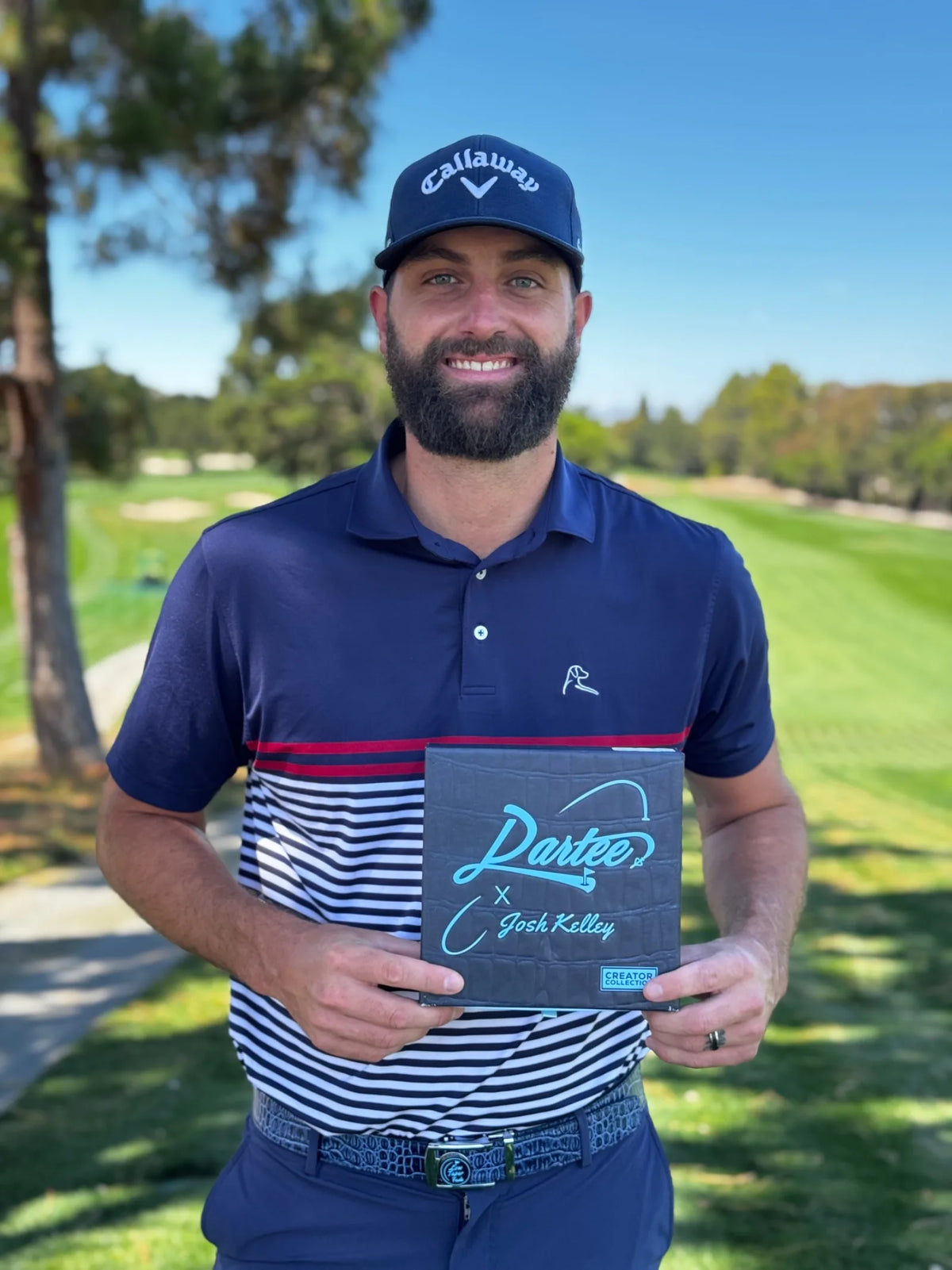 Golfer holding a dark crocodile-embossed Dartee collection box on the course
