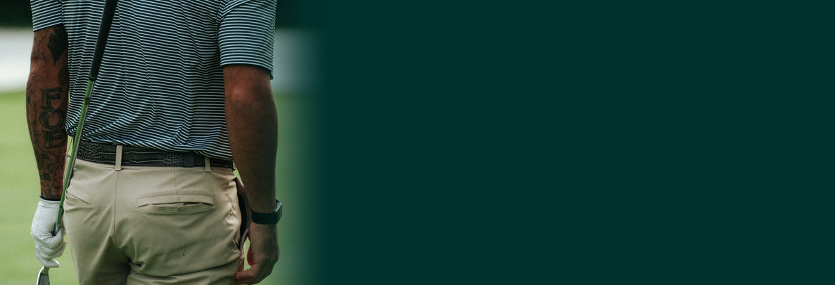 Golfer wearing a Dartee belt on the course